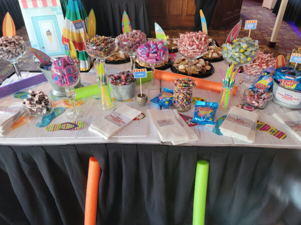 a candy table topped with lots of candy and candies