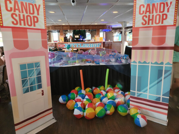 a candy table shop display with lots of balls on the floor