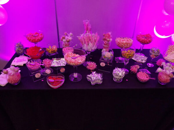 a candy table topped with lots of candy and candies
