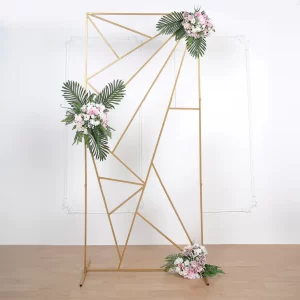 a gold geometric display with flowers and greenery