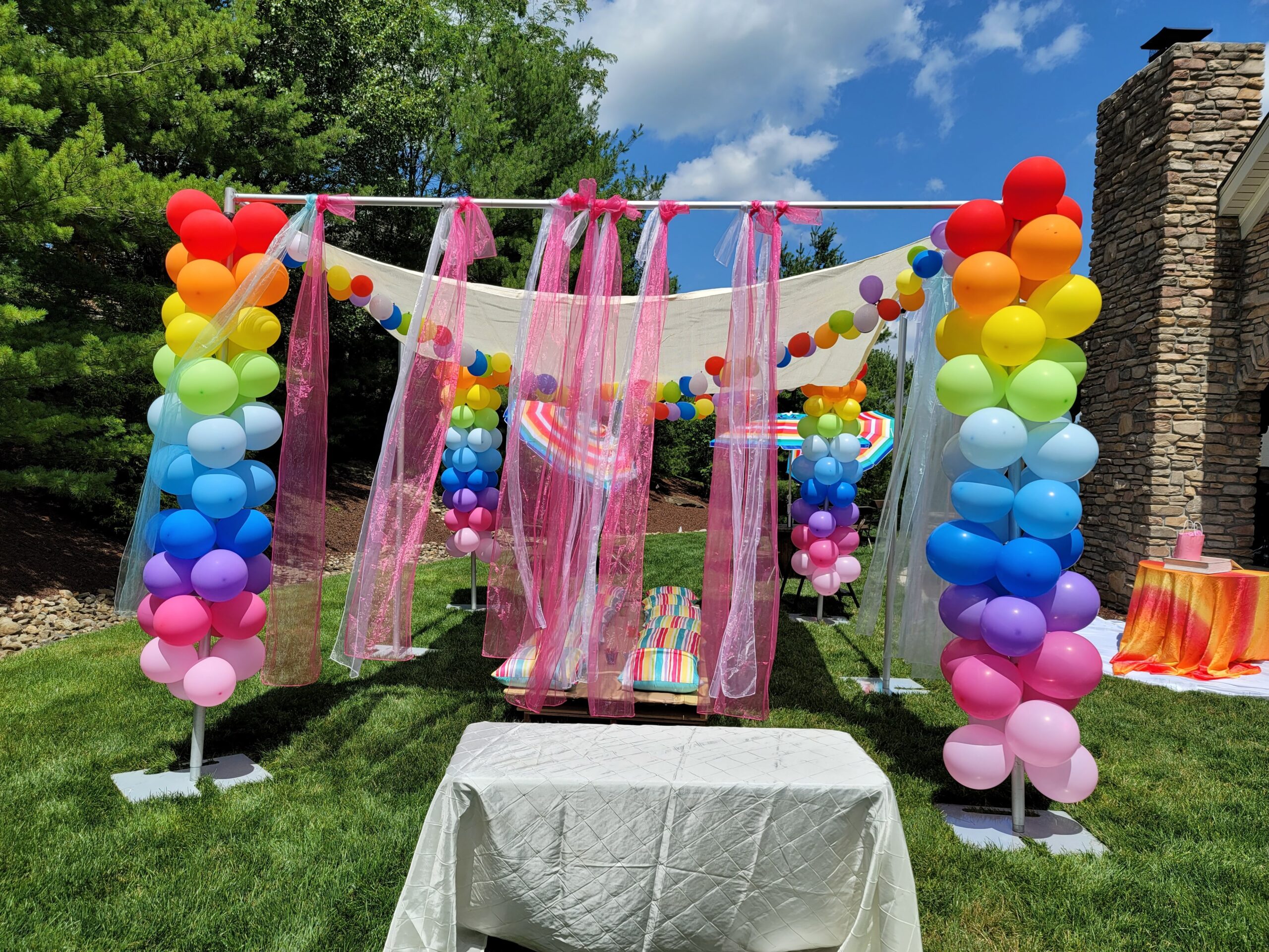 an outdoor party with balloons and streamers