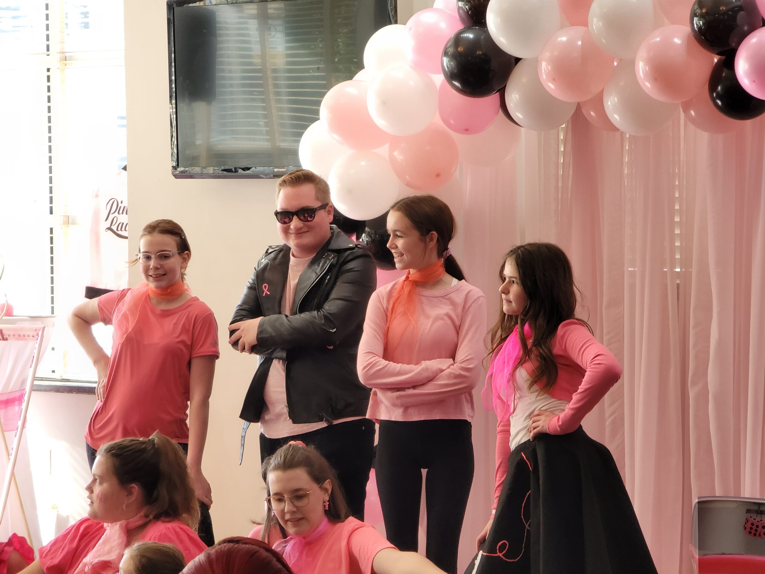 a group of people standing around each other