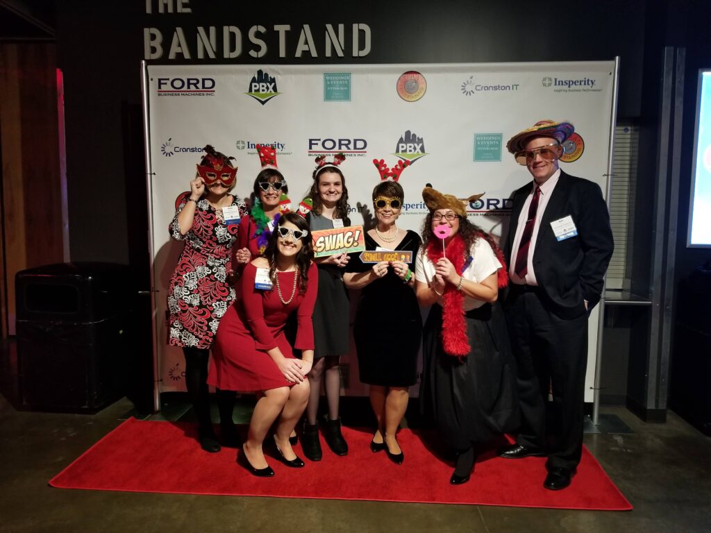 a group of people standing on top of a red carpet