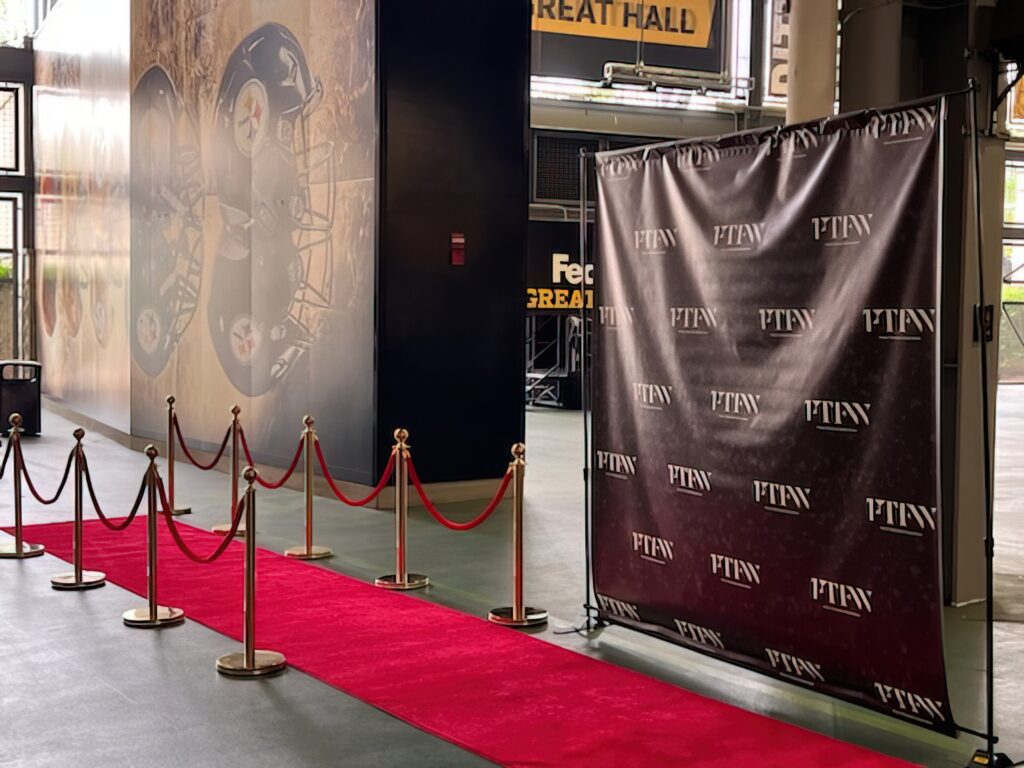 a red carpet with stanchions