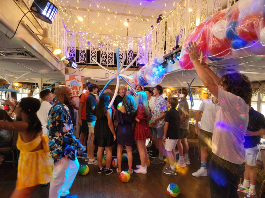 a group of people standing around each other in a room