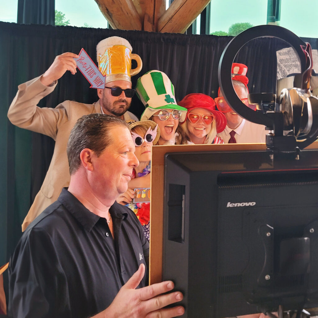 a group of people standing around a photobooth budget