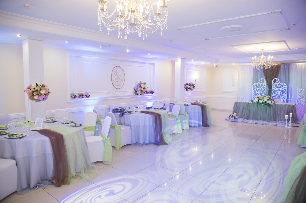 a banquet hall with tables and chairs decorated in pastel colors