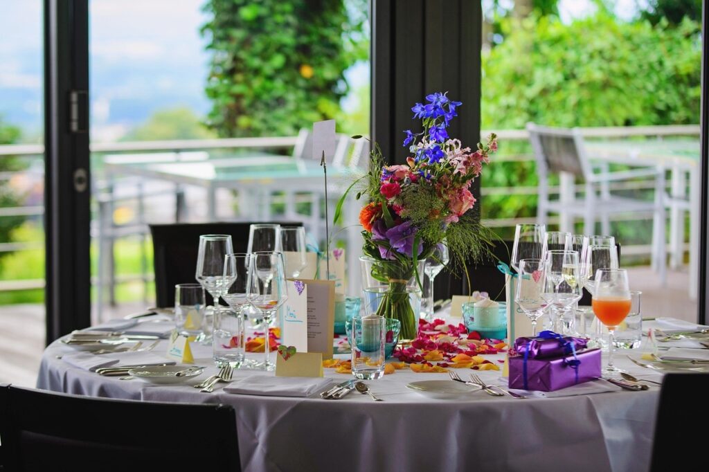 a table set up with wine glasses and flowers