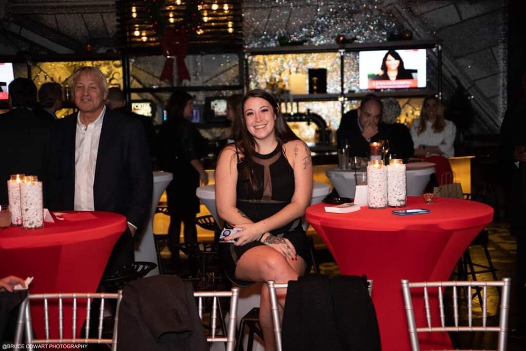 a woman sitting at a table with candles in front of her