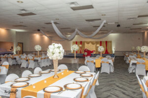 a banquet hall with tables and chairs set up for a formal function