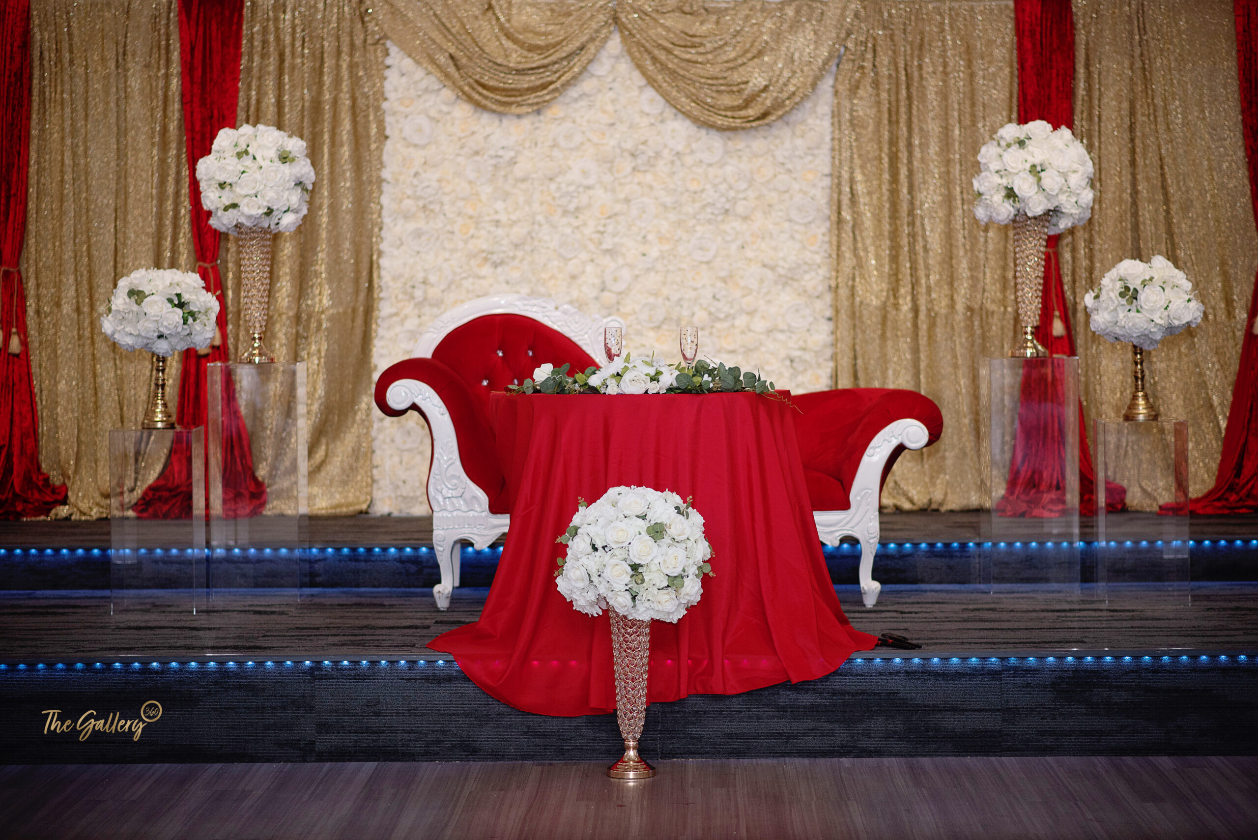 a red table cloth with white flowers on it