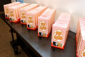 a table topped with lots of orange and white boxes