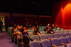 a group of people sitting in a theater