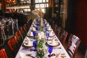 a long table set with place settings for dinner