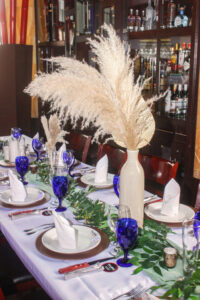 a table set with place settings and flowers