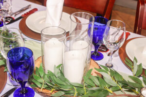 a table set with place settings and candles