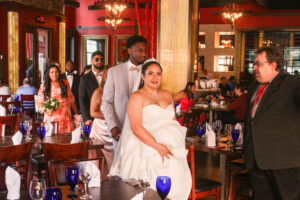 a bride and groom posing for a photo in a restaurant