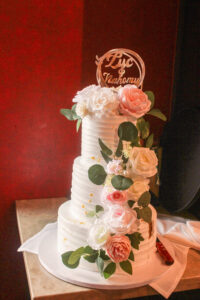 a wedding cake with flowers on top