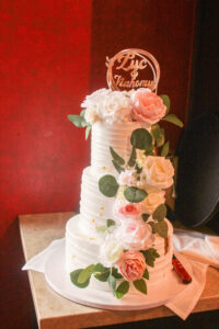 a white wedding cake with flowers on top