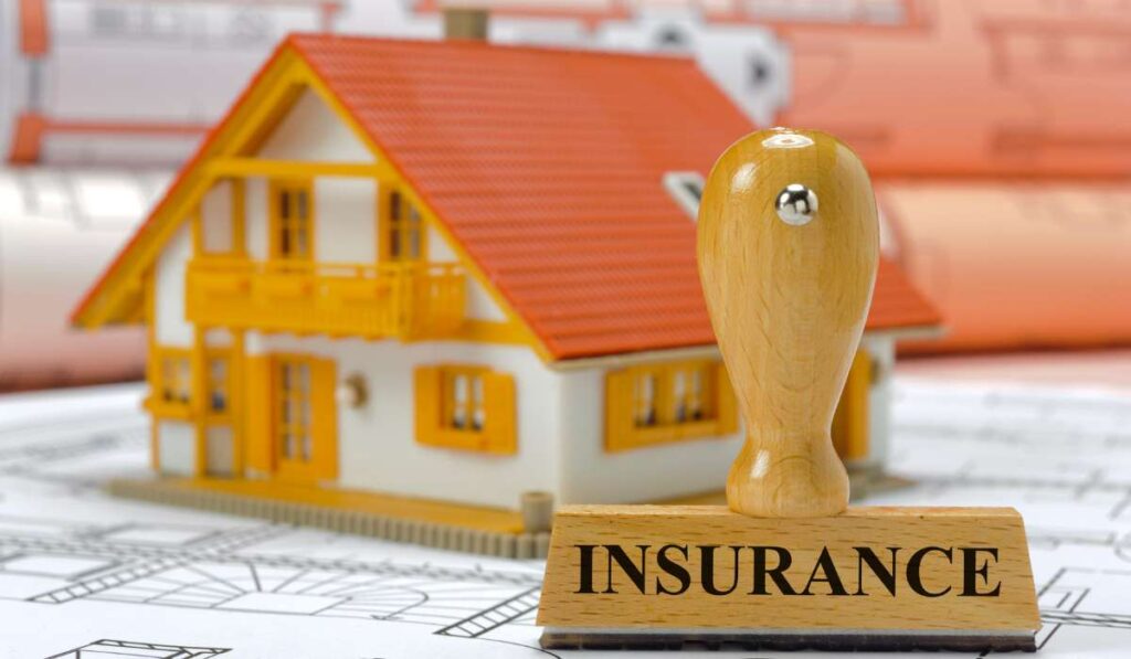 a stamp with the word insurance on it next to a model house