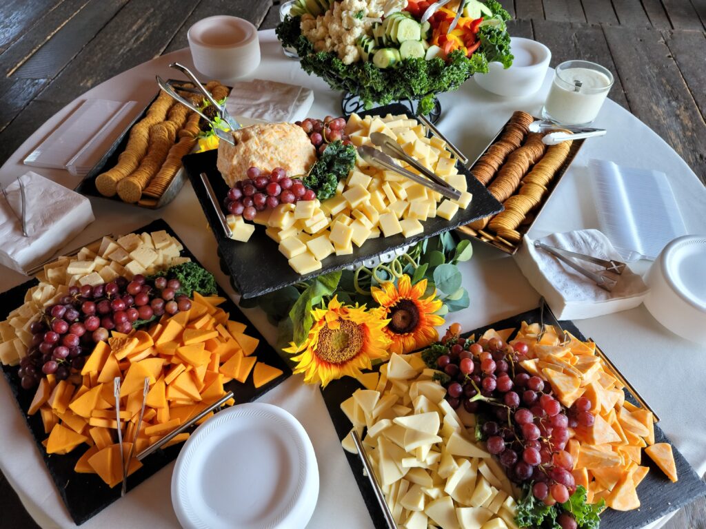 a table topped with trays filled with different types of food