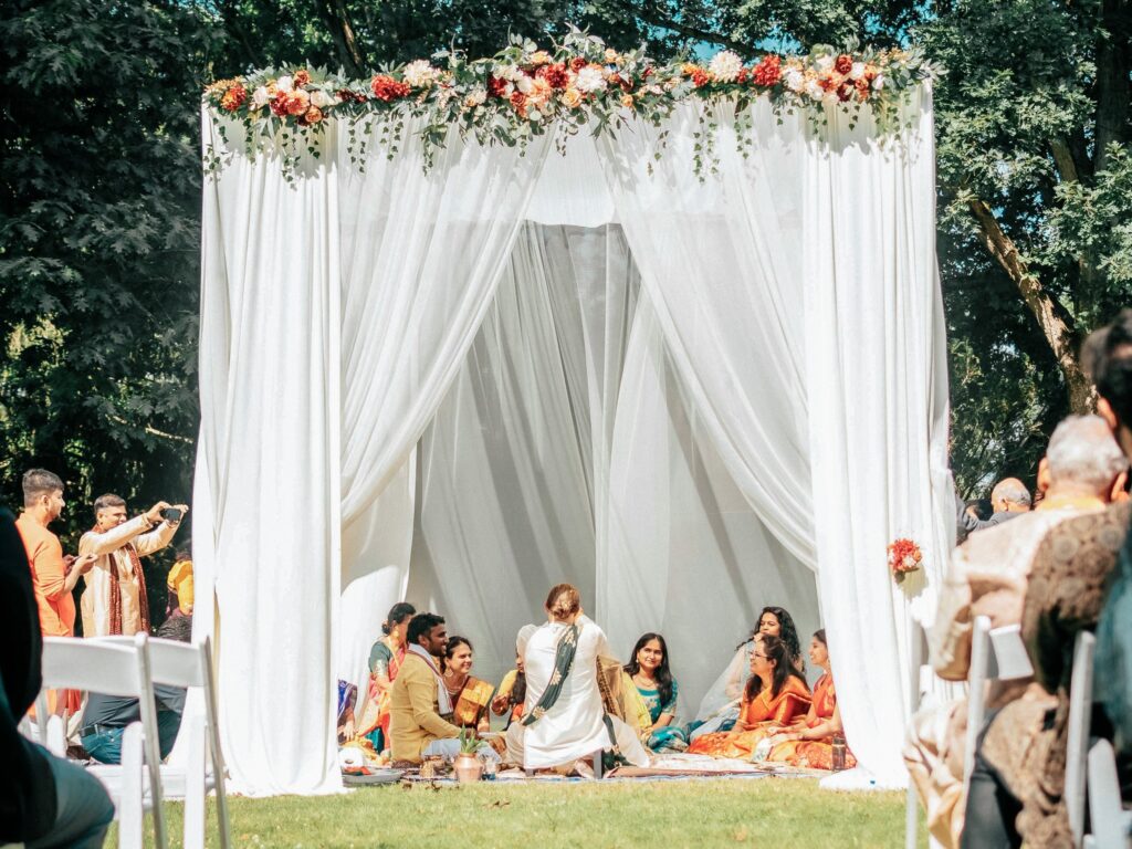 a group of people sitting under a white canopy