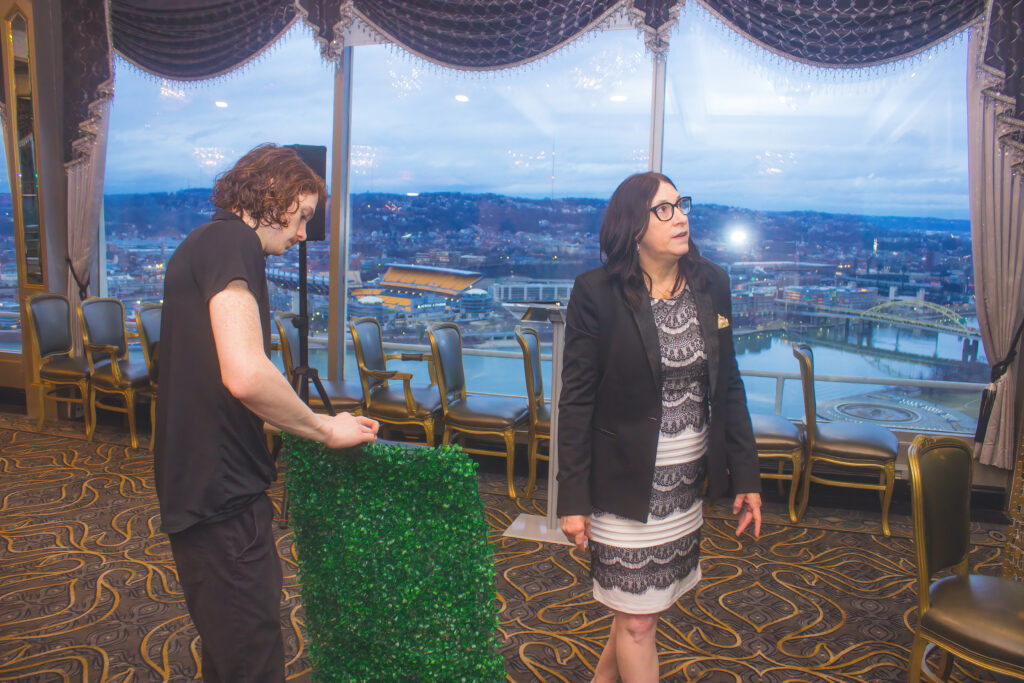 a man and woman standing in front of a window