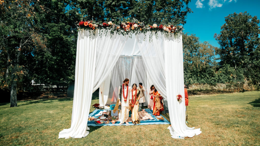 a group of women standing under a white canopy