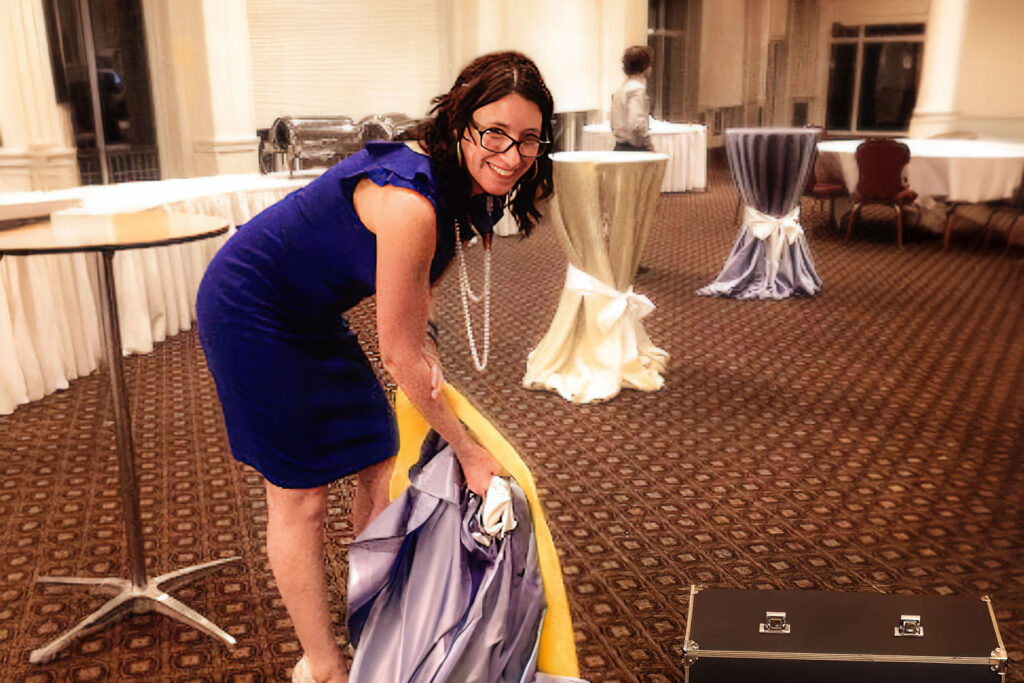 a woman in a blue dress is cleaning a suit case