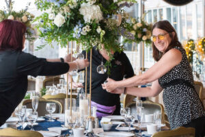 a group of women standing around a table