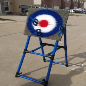 a blue and white sign sitting on top of a sidewalk