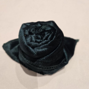 a black hat with a flower on top of it