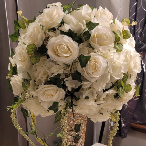 a vase filled with white flowers on top of a table