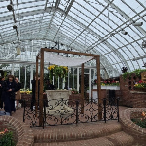 a group of people standing in a greenhouse