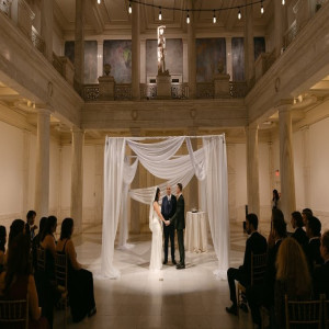 a bride and groom standing in front of a wedding ceremony