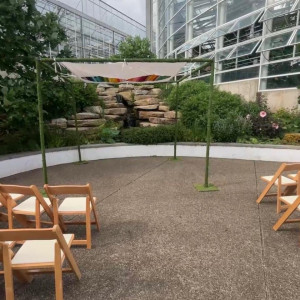 a couple of wooden chairs sitting on top of a cement floor