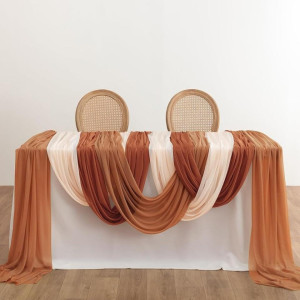 a table with two chairs and a table cloth draped over it