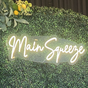 a green wall with a sign that says main squeeze