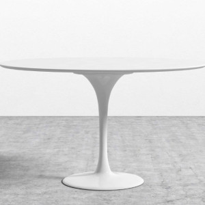 a white table sitting on top of a cement floor