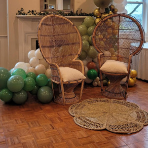 a room filled with balloons and wicker chairs