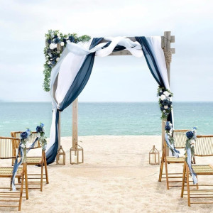 a wedding set up on the beach with chairs
