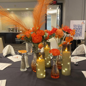 a table topped with vases filled with flowers and candles