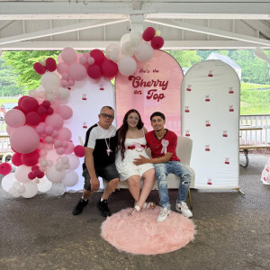 a group of people sitting on a bench under a canopy