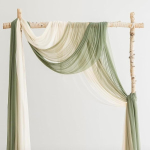 a bed with a green and white drape on top of it