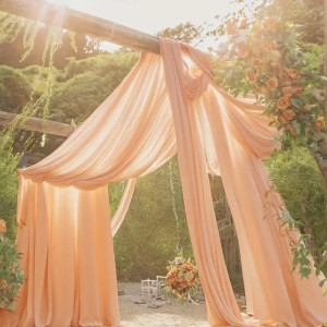 an outdoor ceremony with a canopy and flowers