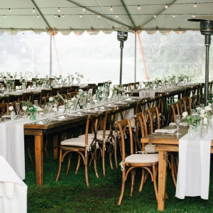 a large tent with tables and chairs set up for a wedding