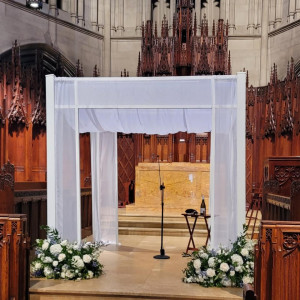 a church with a white altar and flowers on the steps