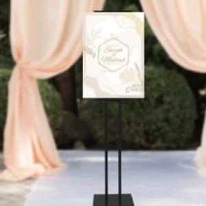 a white sign sitting on top of a black stand