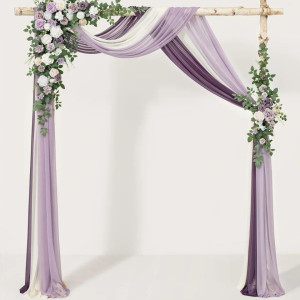 a purple and white wedding arch decorated with flowers