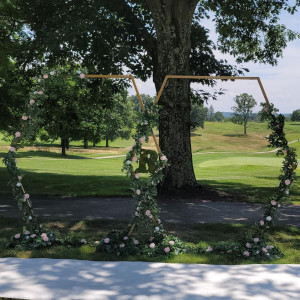 a wooden swing set up in the middle of a park